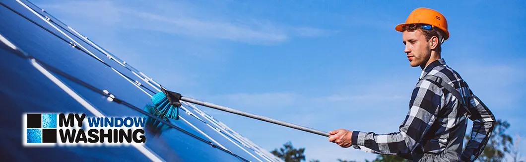 man cleaning solar panels